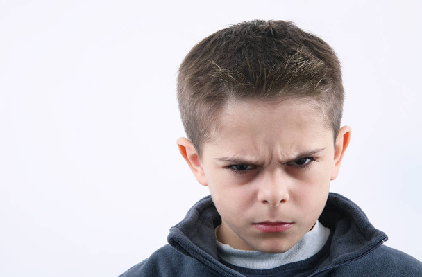 angry young boy in white background - Foto, afbeelding