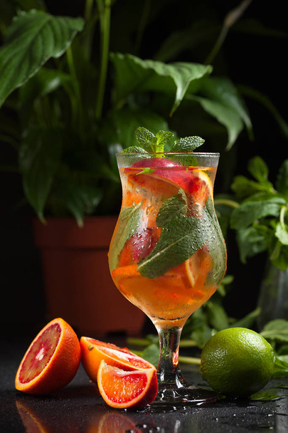 Fresh summer cold orange cocktail with lime and mint - Zdjęcie, obraz