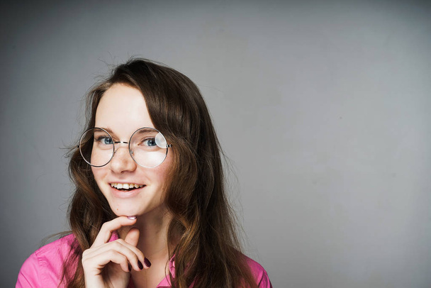 happy young woman office worker in a pink shirt and glasses smiling - Foto, imagen