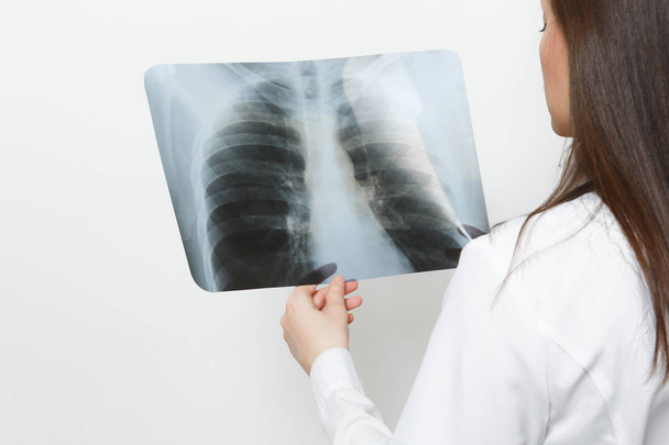 Close-up arts vrouw met X-ray van de longen, fluorography, Röntgen geïsoleerd op witte achtergrond. Vrouwelijke arts in de medische jurk stethoscoop. Medisch personeel, geneeskunde concept. Longontsteking. Achteraanzicht. - Foto, afbeelding
