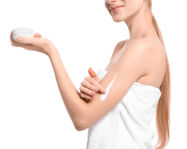 Young woman with jar of body cream on white background - Zdjęcie, obraz