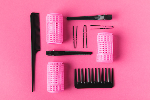 flat lay with curlers, combs and hairclips, on pink - Photo, Image