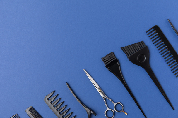 diagonal composition with hairdressing tools, isolated on blue - Fotoğraf, Görsel