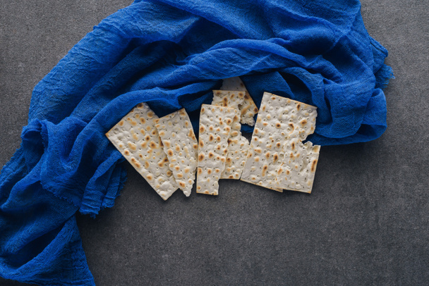 top view of matza on blue tablecloth, Pesah celebration concept - Photo, Image