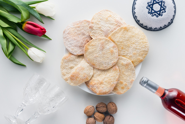 top view of matza and wine on white table, Pesah celebration concept - Photo, Image