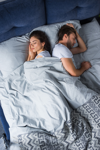 Sleeping man and woman lying in bed - Photo, Image