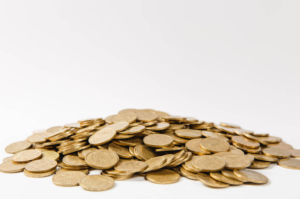 Close up of big pile of golden coins isolated on white background. Concept of money business growth gain success earnings. Copy space for advertisement. With place for text. - Foto, afbeelding