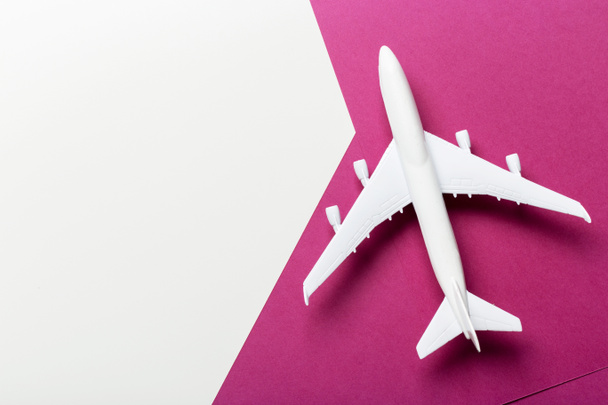 Closeup of miniature airplane on colored background. Travel or vacation concept - Foto, Imagem