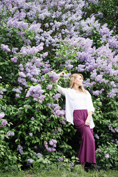 woman near the blossoming lilac - Fotoğraf, Görsel