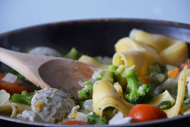 tagliatelle pasta with vegetables, cream-herb sauce, tomatoes - 写真・画像