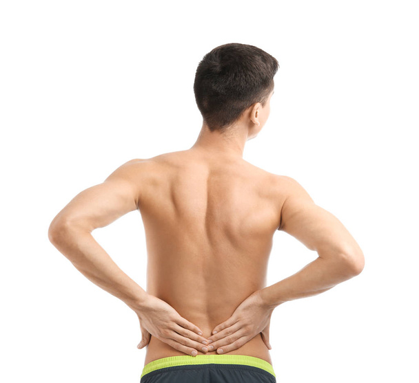 Young man suffering from back pain on white background - Foto, afbeelding