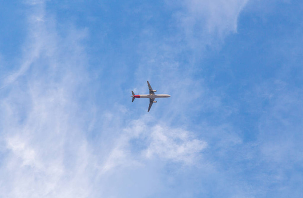 Airplane with blue sky. Low angle shot - Фото, изображение