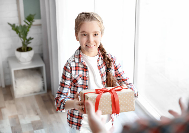 Little girl giving her dad present for Father's Day at home - Foto, afbeelding