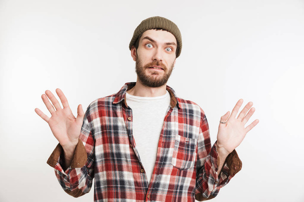 Portrait of a shocked bearded man in plaid shirt - Photo, image