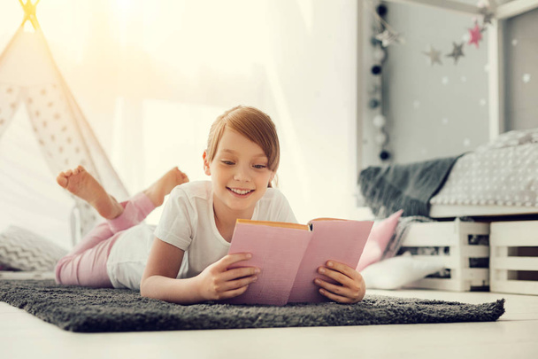 Cheerful happy girl reading a book - Zdjęcie, obraz