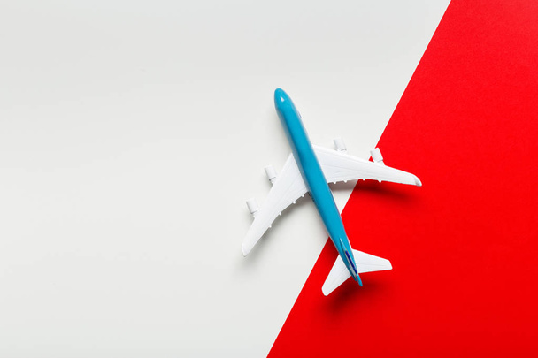 Closeup of miniature airplane on colored background. Travel or vacation concept - Photo, Image