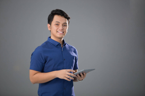 Asian Young Man in Casual using tablet - Photo, Image