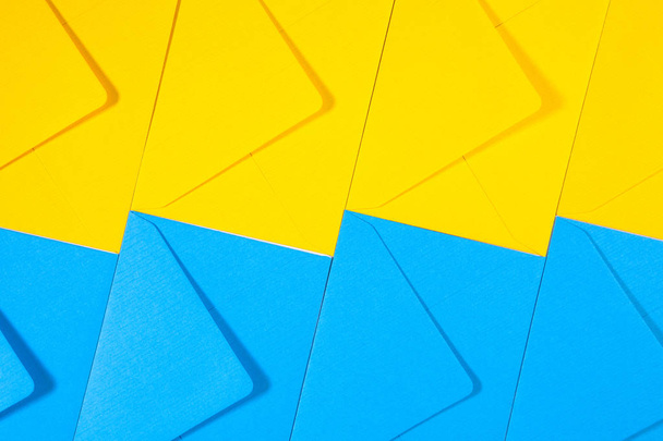 Blue and yellow envelopes on the table - Φωτογραφία, εικόνα