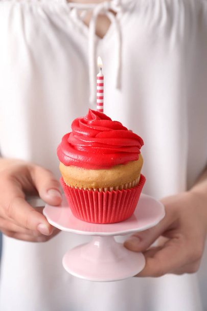 Woman holding stand with birthday cupcake, closeup - Foto, imagen