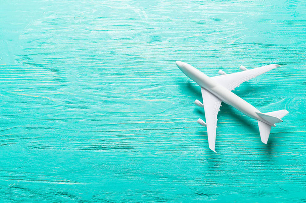 Closeup of miniature airplane on colored background. Travel or vacation concept - Foto, imagen