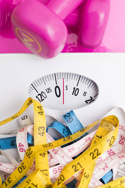 scales with measuring tapes and weights of the gym, concept of diet and beauty - Photo, Image
