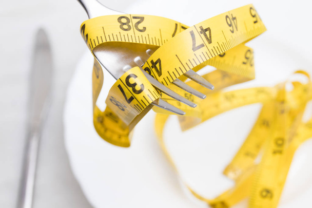 covered with tape measure, diet concept - Foto, Bild