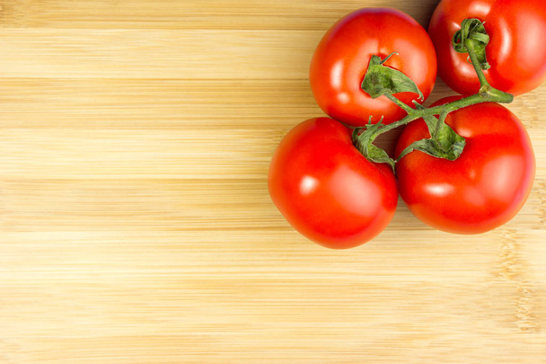 Red tomatoes on a wooden background - Foto, immagini