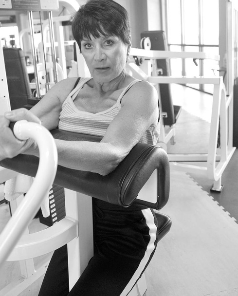 Reife weibliche Schönheit trainiert in einem Fitnessstudio. - Foto, Bild