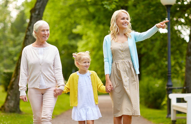 happy mother, daughter and grandmother at park - Photo, image