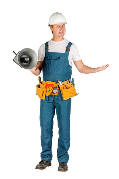 male builder or manual worker in helmet over white wall background. repair, construction, building, people and maintenance concept - Φωτογραφία, εικόνα
