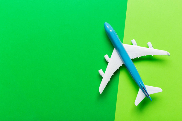 Closeup of miniature airplane on colored background. Travel or vacation concept - Фото, зображення