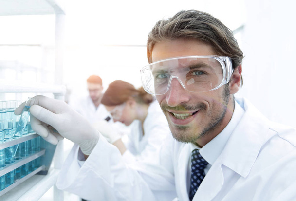 close-up of a happy male scientist wearing safety glasses - Fotó, kép