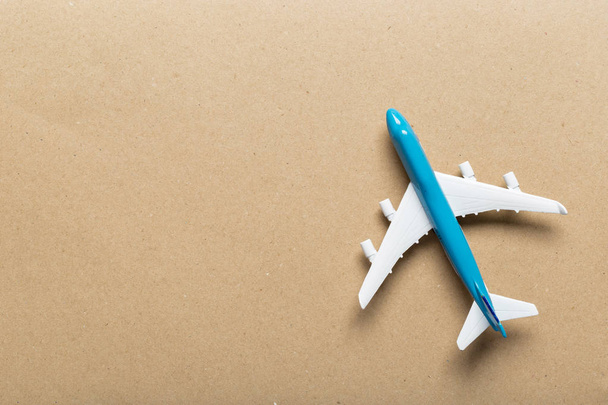 Closeup of miniature airplane on colored background. Travel or vacation concept - Fotoğraf, Görsel
