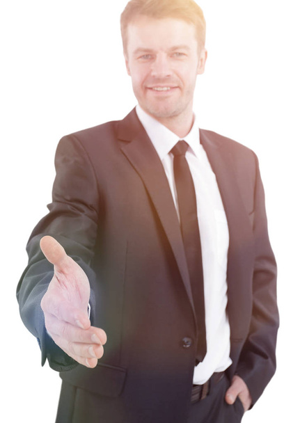 handsome businessman holds out his hand for a handshake. - Fotó, kép