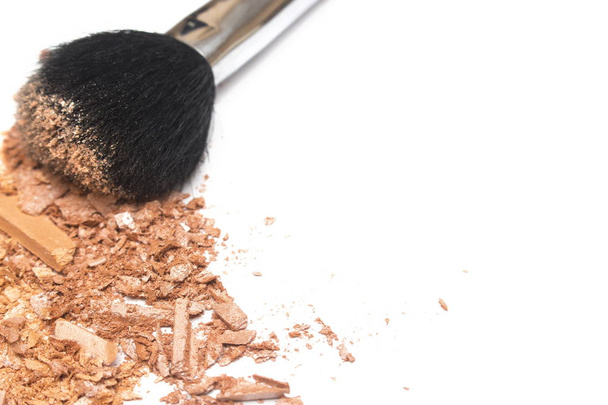 Crushed face powder and powder brush on white background - Photo, Image