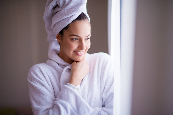 beautiful woman in robe smiling after shower  - Foto, imagen