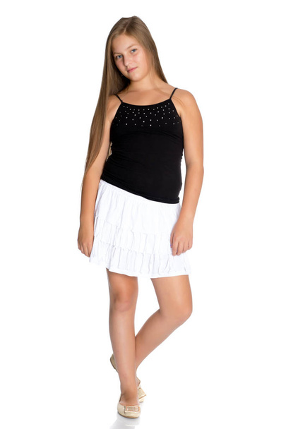 A teenage girl in a short white skirt and a black T-shirt. - Foto, Imagem