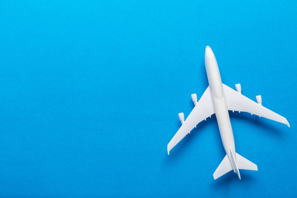 Closeup of miniature airplane on colored background. Travel or vacation concept - Foto, immagini