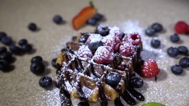 Delicious holiday wafers with raspberries and blueberries / waffles with berries and sweet powder - Кадры, видео