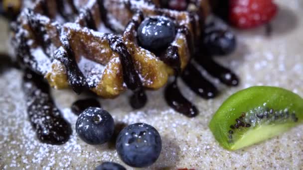 Delicious holiday wafers with raspberries and blueberries / waffles with berries and sweet powder - Imágenes, Vídeo
