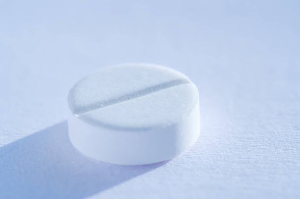 Pill tablet medicine lying isolated on white, extreme close-up macro. - Valokuva, kuva