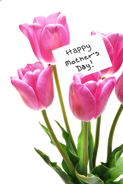Happy Mothers Day tag among a bunch of purple tulips isolated on a white background - Photo, Image