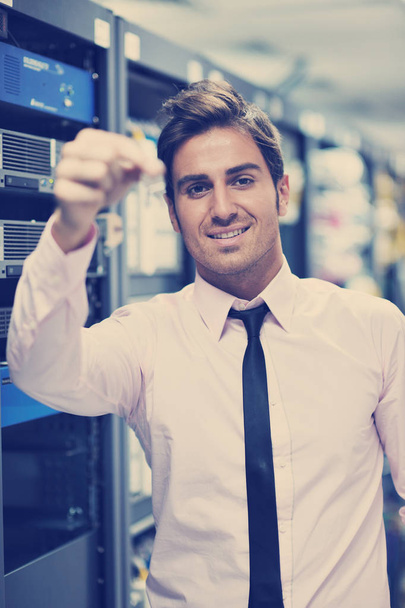 young handsome business man  engeneer in datacenter server room - Photo, image