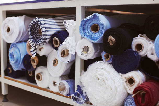 Fabric rolls in storage on cloth factory - Foto, imagen