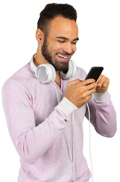 Portrait of young African american man with headphones and smartphone - Foto, Bild