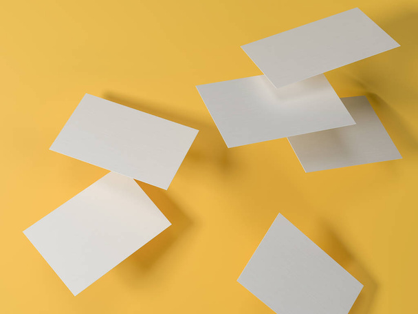 render 3d images of business cards dynamically scattered on a yellow background. - 写真・画像