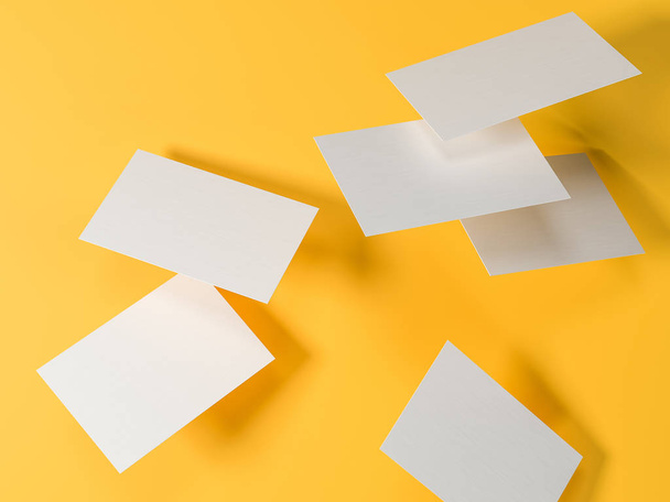 render 3d images of business cards dynamically scattered on a yellow background. - Foto, afbeelding