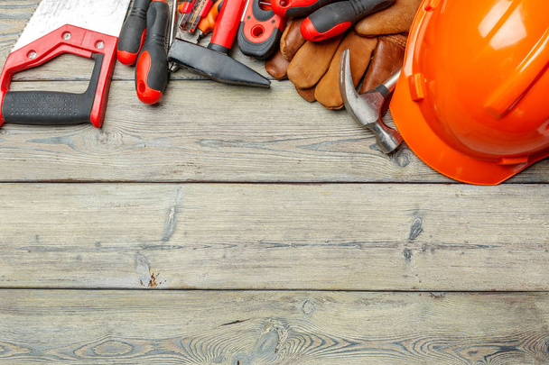 Assorted work tools on wooden table - Фото, зображення