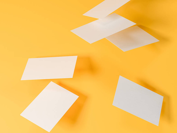 render 3d images of business cards dynamically scattered on a yellow background. - Foto, imagen