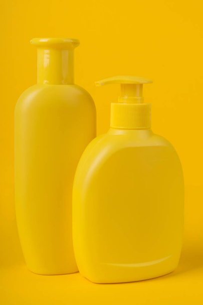 Group Cosmetic Bottles Isolated on Yellow Background. - Foto, Imagen
